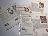 a lot of old letters and stamps on top of a table