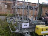 a trailer with a cart attached to it in the grass
