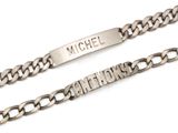 silver chain with name engraved on it on a white background