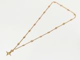 a gold necklace with a star charm on it