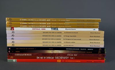 many books stacked on top of each other on a table
