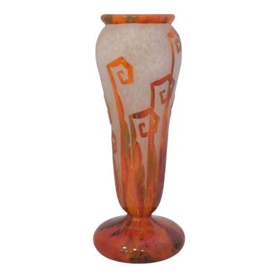 orange and white glass vase with a design on the base