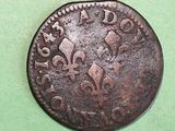 a close up of a coin on a green surface