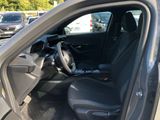 the interior of a car with the door open and the driver ' s seat down