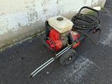 a small red and black machine on the ground