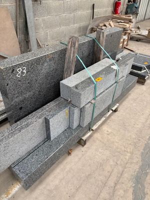 a pile of granite blocks sitting on a pallet in a warehouse