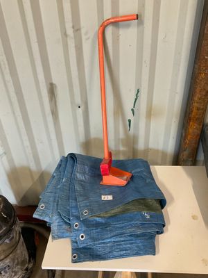 a table with a pair of jeans on it and an orange handle