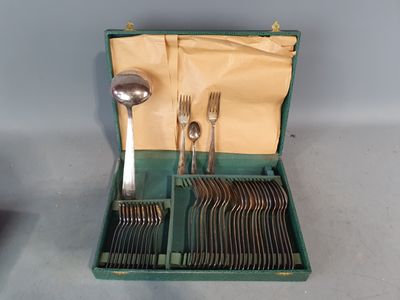 un coffret vert contenant de l'argenterie sur une table