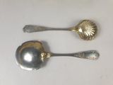 two spoons that are sitting on a table