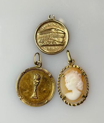 two gold and cameo cameo pendants, one with a woman ' s head