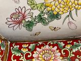 a close up of a vase with flowers painted on it