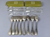six forks and spoons are sitting on a table next to a box of silverware