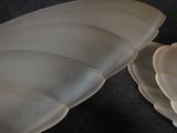 two pieces of white plastic sitting on a black surface