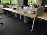 a desk with two laptops on it in an office