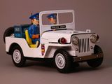 a toy jeep with a policeman in the back of it
