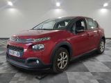 the red citrole is parked on a checkered tile floor