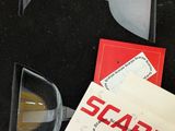 a black case with a pair of scissors and a piece of paper in it