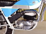 a blue and white dirt bike parked in a garage