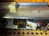 a stainless steel table with a lot of food inside of it
