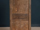 an old wooden cabinet with two doors on top of it