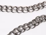 a close up of a metal chain on a white surface