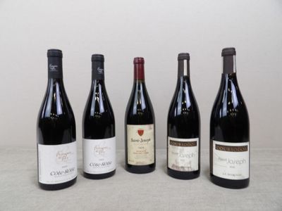 quatre bouteilles de vin sont alignées sur une table