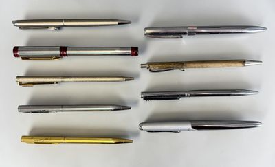 several different types of pens are lined up on a white surface