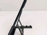 a black tablet computer sitting on top of a stand