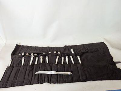 a roll - up knife holder with a knife in it