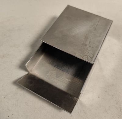 a metal box that is open on a table