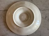 a white plate on a marble table with a white bowl on it