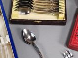 a lot of silverware in a box on a table