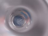a close up of a glass of water with a clock in it