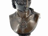 bronze bust of a woman on a wooden base on a white background