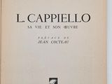 an old book with a black and white cover on a white surface