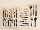 many different types of silverware laid out on the table