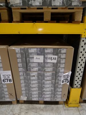many boxes that are stacked on a shelf in a store
