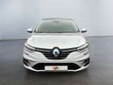 the front view of a white car parked in a showroom