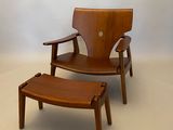 an image of a wooden chair and foot stool in a white room
