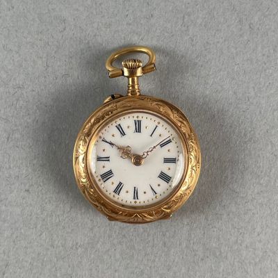 a gold pocket watch with roman numerals on it