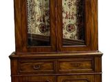 an image of a wooden china cabinet with glass doors