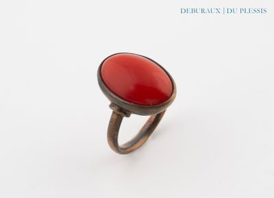an image of a ring with a red stone in it