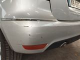 a close up of a car ' s bumper with a number plate on it