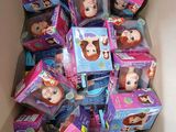 a cardboard box full of dolls and other toys