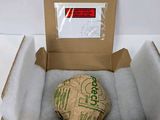 a cardboard box with a ball in it on a white surface