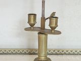 a lamp that is sitting on a table with a bird on it