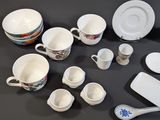many different types of cups and saucers on the table