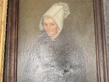 painting of a woman in a white hat and a brown frame