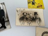 several old photos of men and women are hanging on a wall
