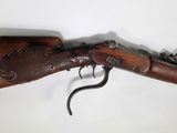 an old rifle with a wooden handle and a metal handle